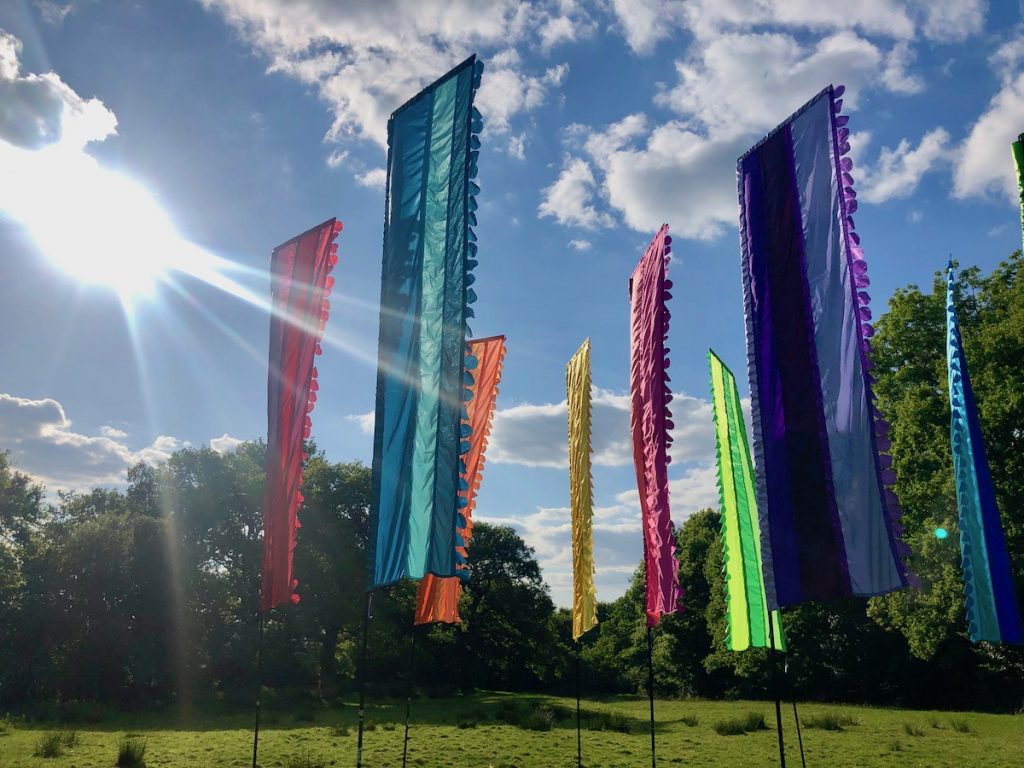 A field of bright stripe flags in sunshine.
