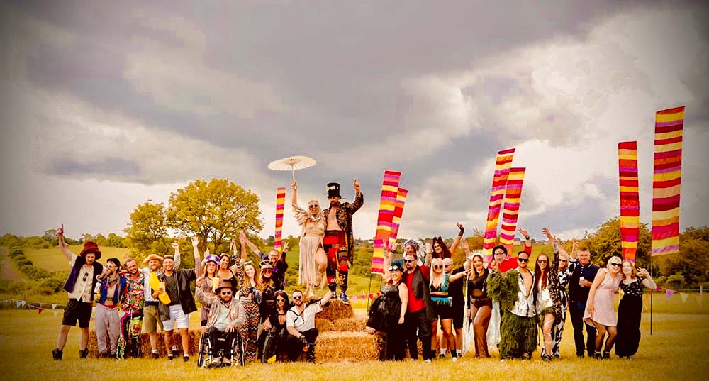 wedding group shot with colourful warm hue calypso flags