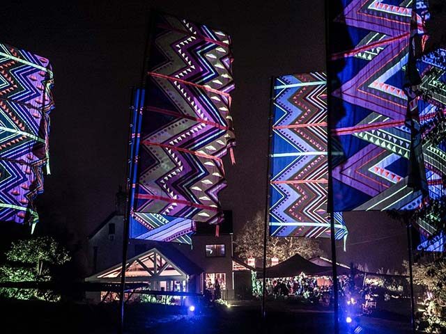 festival style party with extra large neon mexican flags