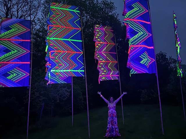 guest enjoying huge neon mexican flags glowing in twilight