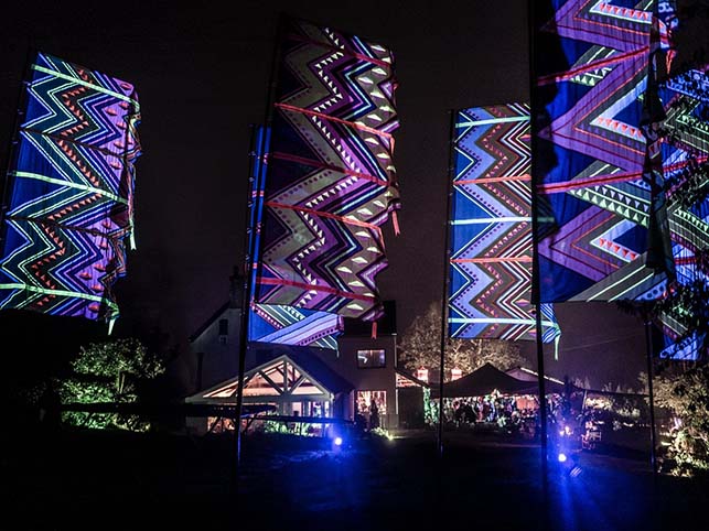 mexican pattern neon flags flying at night at festival event in somerset