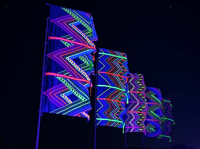 neon mexican aztec design flags illuminated at night by uv lighting