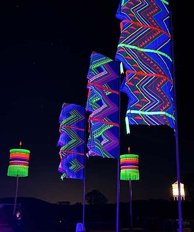 neon flags with lanterns glowing in the dark available to hire for parties and events